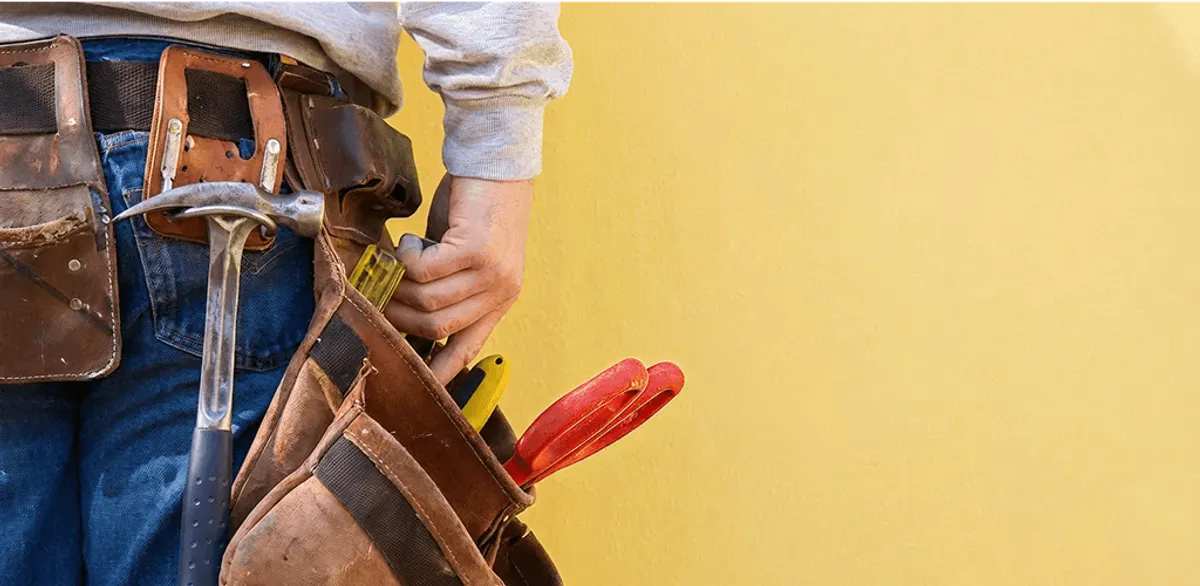 Handyman with tool belt ready for home repairs and maintenance in Buffalo, NY
